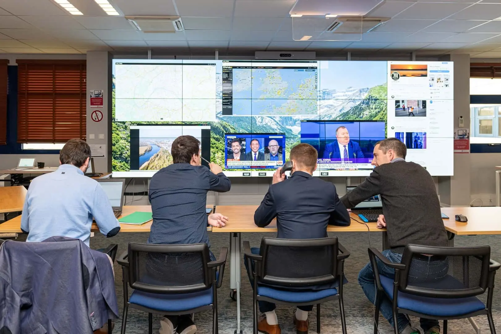 Photo showing people working together around a table using CWall.